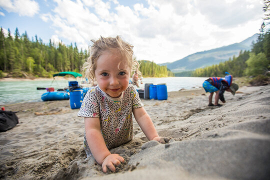 Young girl with a messy face playing in the sand