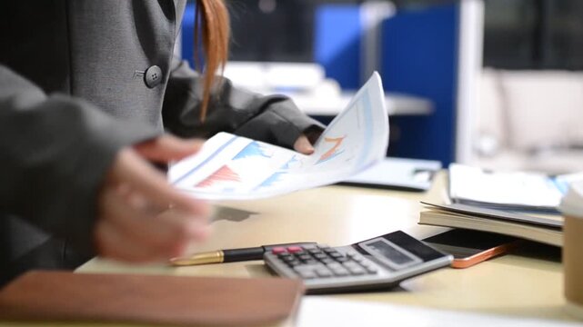Human use calculator and calculate bills and paying bill, credit card, tax and vat, payment, concept of money management and business report with financial documents, financial accounting concept