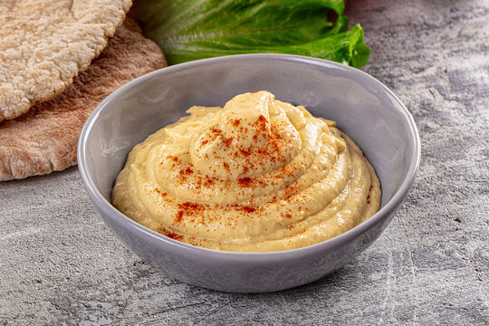 Classic hummus dip with paprika and pita bread