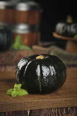 Fresh Black Winter Squash with Mint on Rustic Wood © TranVan