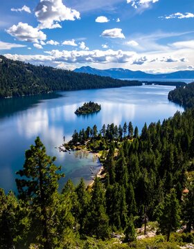 Scenic lake vista with lush greenery and puffy clouds