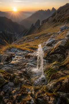 Mountain spring bubbling among rocks at sunrise