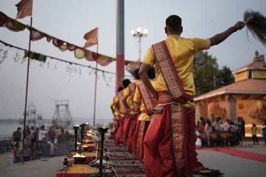 Morning Ganga aarti rituals performed by unrecognized Hindu priests at Assi Ghat in Varanasi with selective focus. Fire in the brass made utensils for Aarti in Banaras.