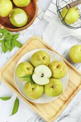 Fresh Green Pears on White Plate and Wooden Board Flat Lay © CanVan