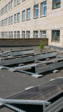 The Concept of Green Energy in an Urban Environment. Solar panels on the roofs of old apartment buildings. A rooftop solar power plant - Vetical video