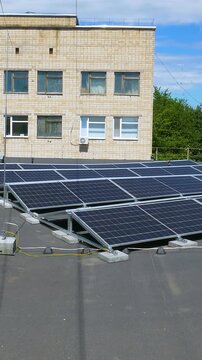 The Concept of Green Energy in an Urban Environment. Solar panels on the roofs of old apartment buildings. A rooftop solar power plant - Vetical video
