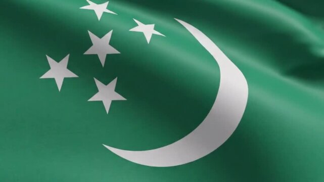 Close up of the national flag of turkmenistan waving in the wind showing the intricate red carpet pattern and green field