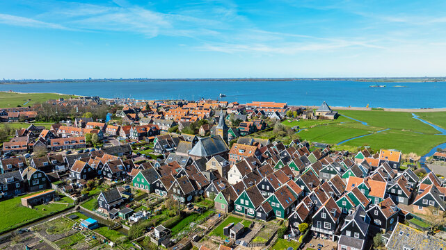 Traditional houses and prominent church in a historic lakeside village in Europe