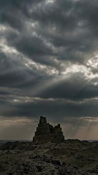 Tower of Babel ruins under dark dramatic sky. Ancient stone structure in desert landscape. Biblical history and monumental architecture mythology concept. Vertical video