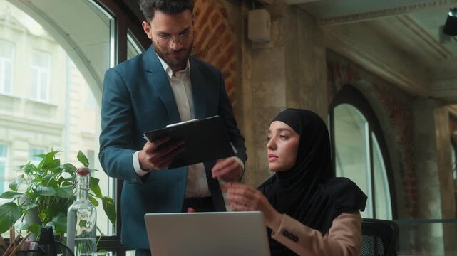 Arabian business team businessman checking diagram mistake angry leader coming displeased angry talking scolding Muslim businesswoman with laptop manager bad work incompetent worker documents problem