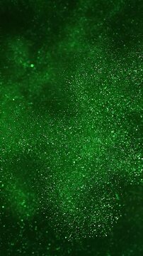 Green glitter background effect, vertical video featuring shimmering sparkling particles, elegant festive motion and luxurious abstract light animation