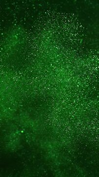 Green glitter background effect, vertical video featuring shimmering sparkling particles, elegant festive motion and luxurious abstract light animation