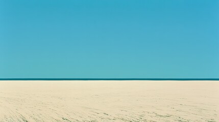 Fototapeta premium Vast, bright sky meets a sandy expanse, divided by a thin horizon