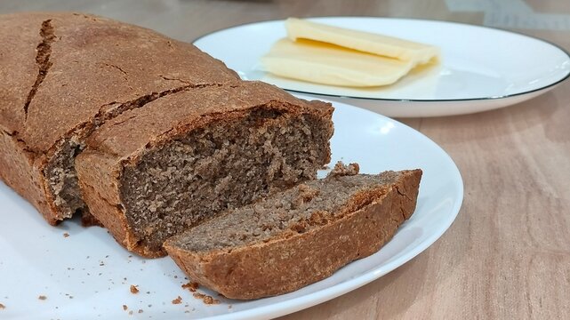 Homemade Rye Bread Loaf with Cheese on Table