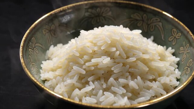 A bowl full of large rice writes steaming hot rice