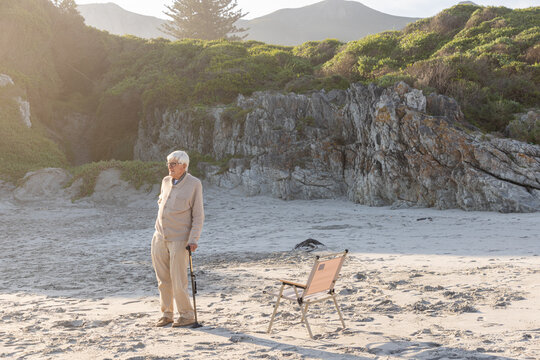 elderly man enjoying beach time, misty grotto beach, hermanus, South Africa