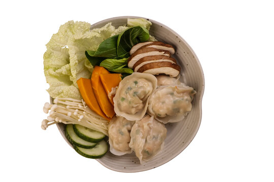 Asian dumplings with fresh vegetables and mushrooms in a bowl