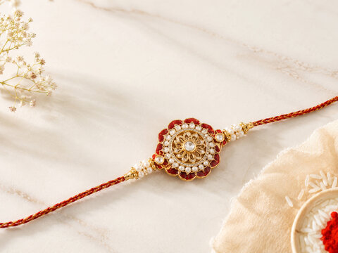 Premium Handmade Rakhi Bracelet on Minimal Marble Background with Copy Space for Raksha Bandhan