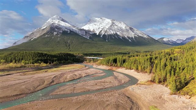 Drone view of snowy peaks near Abraham Lake shore