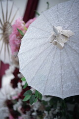 Elegant White Lace Parasol with Floral Wedding Decoration Background © sifa