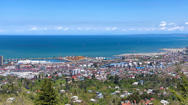 Panoramic view of Batumi city and Black Sea coast from Argo Cable Car viewpoint, Georgia. Urban skyline, seaport infrastructure and blue bay under a clear summer sky.