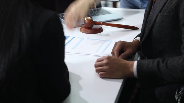 Close up of businessmen or lawyers discussing contract or business agreement at law firm office, Business people making deal document legal, justice advice service concept.