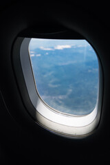 Fototapeta premium Airplane window view during cruising altitude flight. Concept tourism, travel and modern aviation. 