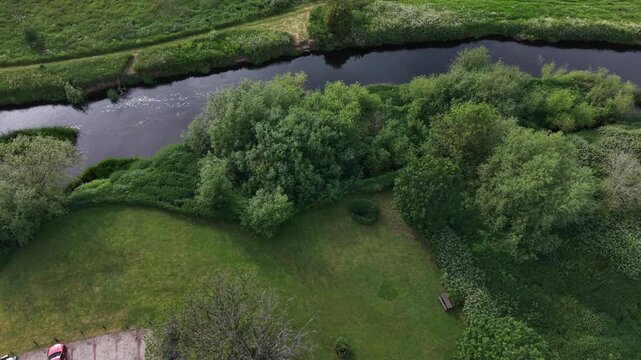 Aerial drone 4K footage showing the town centre surrounded by natural countryside vegetation with warm daylight shaping the landscape Burton on Trent