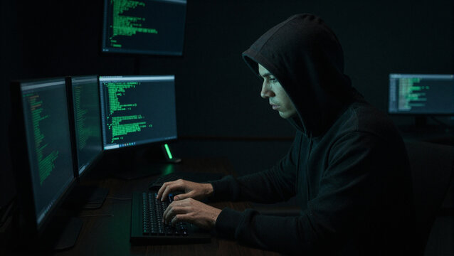 hacker working on a multi screen setup