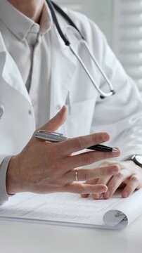 Doctor writing a medical prescription or diagnosis for patient, providing professional healthcare consultation and treatment plan in a clinic or hospital setting