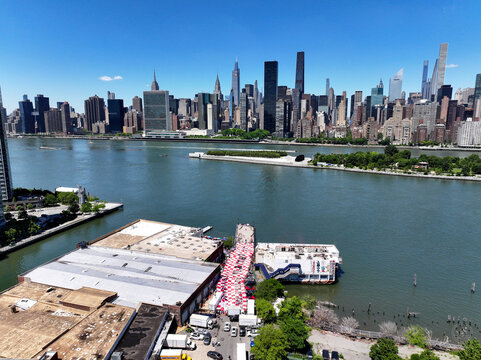 Long Island City, United States - 13 June 2026: Aerial view of a fan zone with Croatian checkerboard patterns on the waterfront, overlooking the East River and Manhattan skyline.