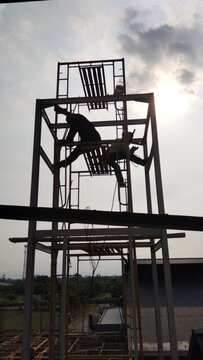 construction worker in the sunset on the project site of a tower building