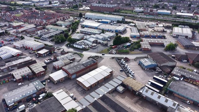Aerial drone 4K scene showing central buildings positioned beside a natural river landscape with bright greenery Burton on Trent
