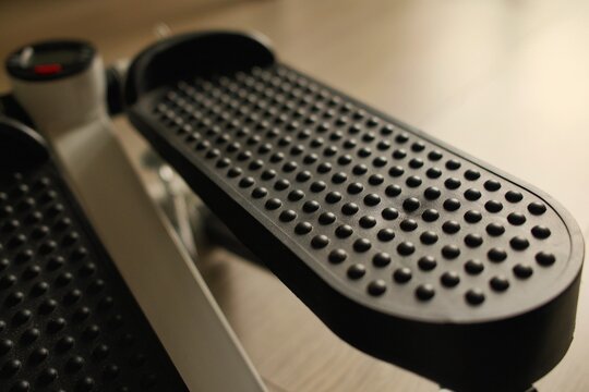 Macro shot of a non-slip pedal surface on a mini stepper exercise machine. Perfect for fitness, workout equipment, and sports technology concepts.