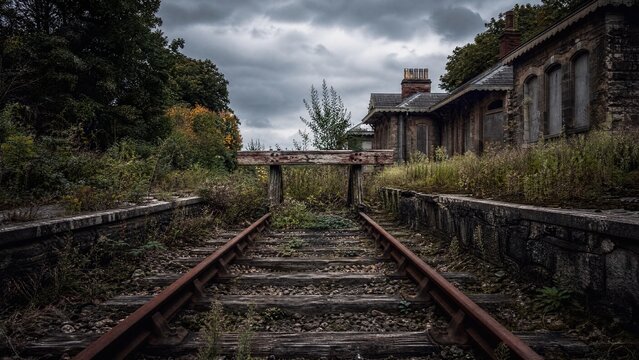 weedy. Rusty end tracks of an old railway station disappearing into weeds. mobility guides, transit brochures, designed for mobility and urban transit guides, used by project managers.