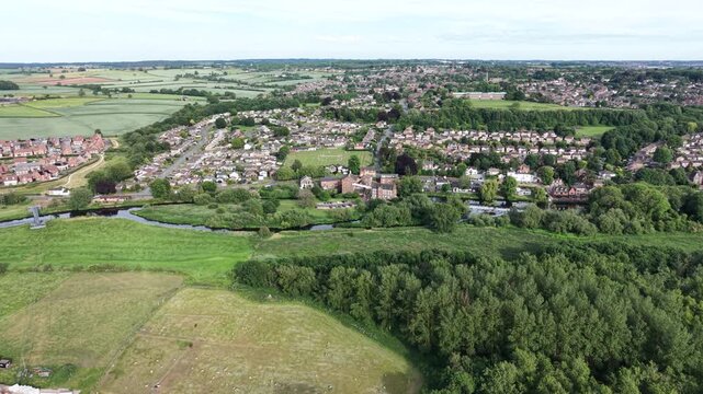 Aerial drone 4K footage showing the town blending into countryside greenery with bright natural tones Burton on Trent