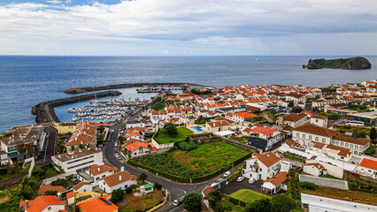 Coastal town overview with harbor marina waterfront and distant volcanic islet © Андрей Нелупов