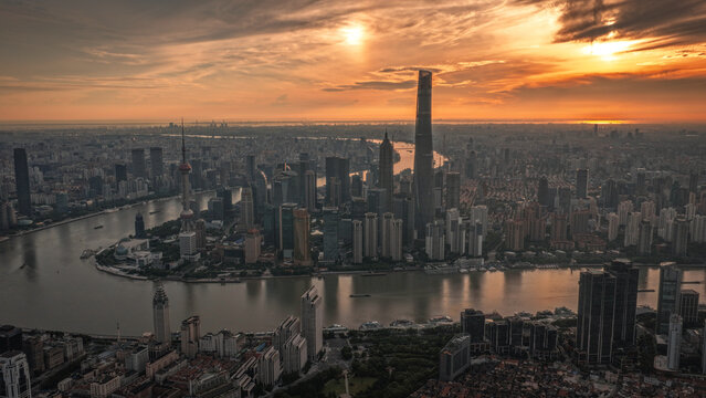 Aerial view of Lujiazui skyline featuring the Shanghai Tower and Oriental Pearl Tower along the Huangpu River at sunset in Shanghai, Shanghai, China.