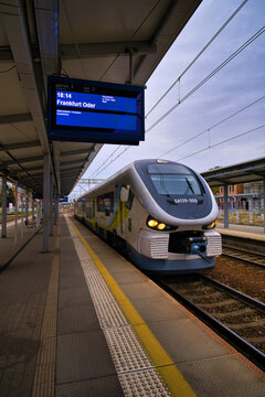Modern Commuter Train At Platform In Station Zielona G&oacute;ra Bound For Frankfurt Oder With Electronic Departure Board.