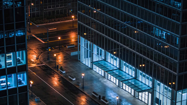 City street glows in rain, Silent urban night with reflections and dim street lighting