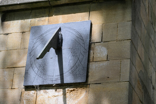 Historic Stone Sundial on Church Wall at Waltham Abbey