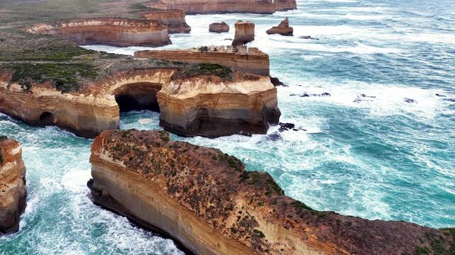 Lift from Razorback sandstone rock of Twelve apostles marine park up to sky &ndash; aerial.