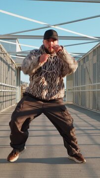 Man wearing zebra print hoodie cargo pants urban street fashion portrait vertical reel background