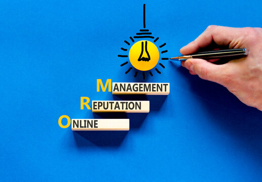 ORM online reputation management symbol. Concept words ORM online reputation management on beautiful wooden blocks. Businessman hand. Beautiful blue background. Business ORM concept. Copy space.