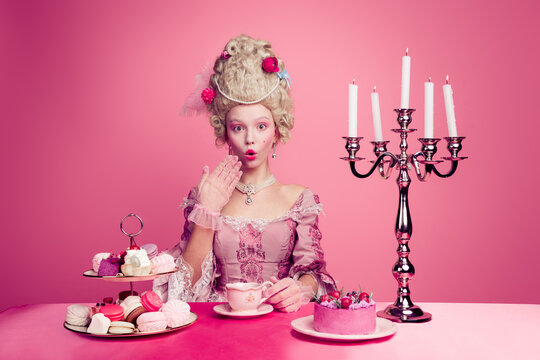 Photo of beautiful princess british lady queen enjoy banquet drinking tea english breakfast isolated on pink color background