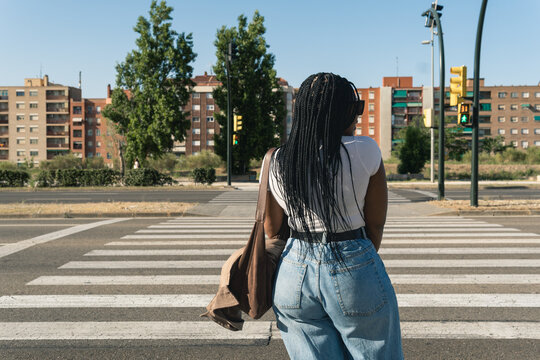 Woman waiting at city crosswalk