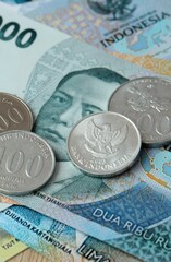Indonesian rupiah money bills and coins on table. Indonesia cash of IDR currency © Larysa