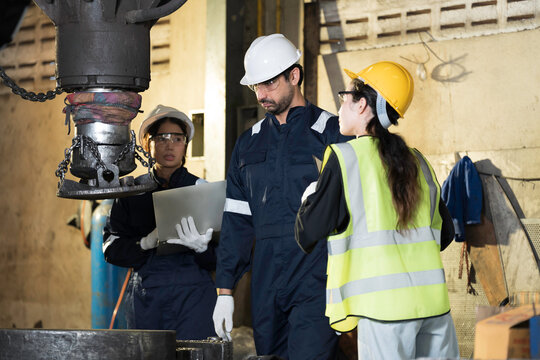 Job training, factory worker, engineer at work. Industrial engineer at work, discussion and working with factory machinery