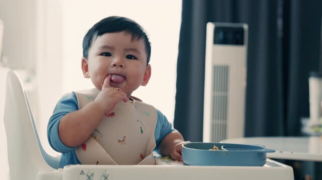 Cute Asian Toddler Eating Finger Food at Home, Healthy Childhood and Family Lifestyle in 4K