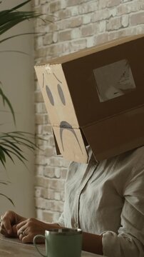Internet computer security concept with worried carton box on the head. People working on laptop with password and vpn anonymous problems. White collar worker writing on wen page in technology leisure